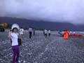 wife buying fish on beach